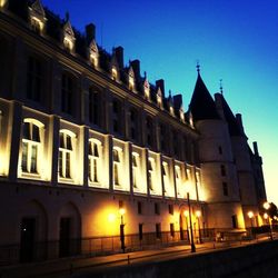 Low angle view of buildings against sky at night