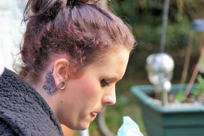 Close-up of young woman looking down