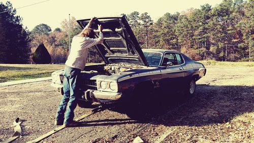 Man in car against sky