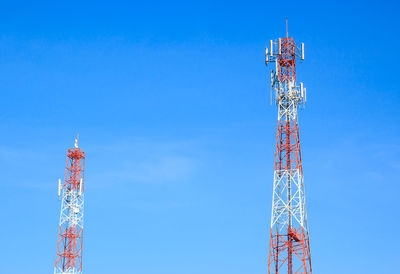 Low angle view of communications tower against blue sky