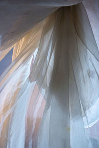 Digital composite image of woman standing in curtain