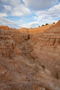 Scenic view of desert canyon against sky