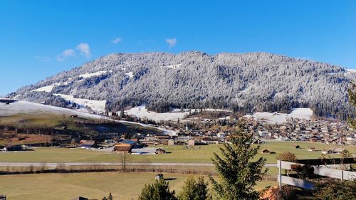 Scenic view of townscape against clear blue sky