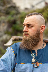 Close-up of man looking away outdoors