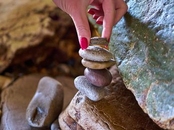 Cropped image of woman hand stacking pebbles