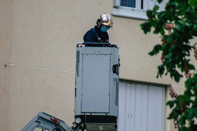 Man working on wall of building