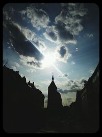 Low angle view of buildings against cloudy sky