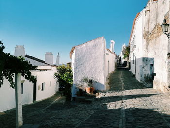 View of buildings against clear blue sky