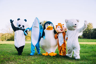 People wearing costume standing at park outdoors