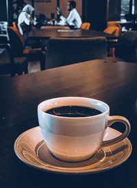 Close-up of coffee served on table at cafe