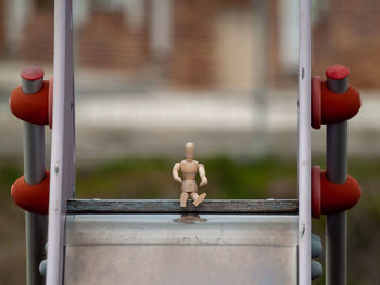 Close-up of stuffed toy on metal structure