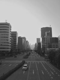 View of city street and buildings against sky