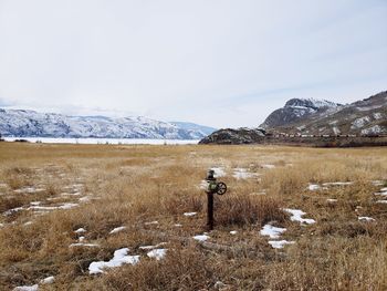 Scenic view of snow covered field against sky