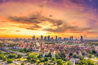 Aerial panorama of warsaw, poland over the vistual river and city center in a distance. sunset sky