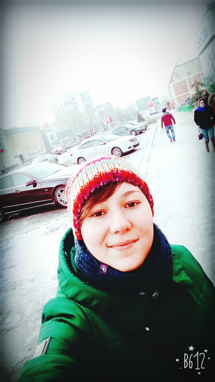 PORTRAIT OF HAPPY WOMAN IN SNOW