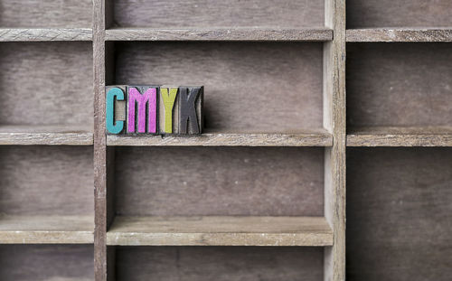 Close-up of colorful toy blocks on wooden shelf