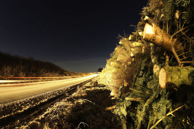 Light trails on road along landscape