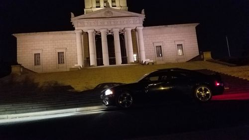 Cars on illuminated car at night