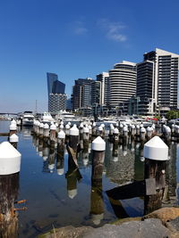 Buildings in city against clear blue sky
