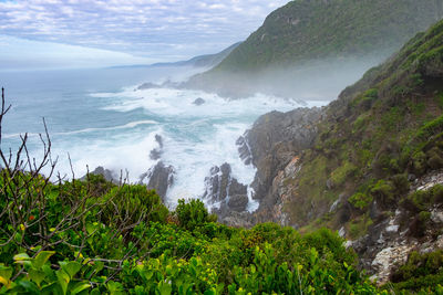 Coastline hike in the mist with waves crashing 