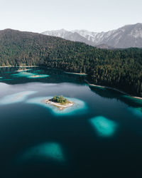 Scenic view of lake by mountains against sky