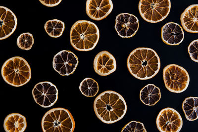 Close-up of grapefruits arranged over black background