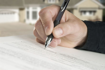 Close-up of man hand holding paper with text