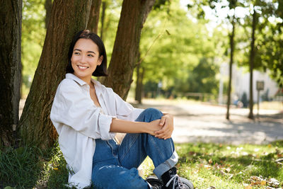 Portrait of young woman using mobile phone