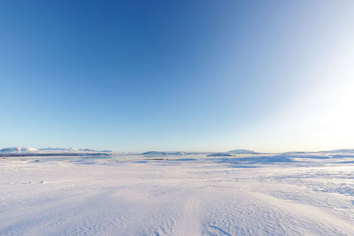 Scenic view of snowcapped landscape against clear blue sky