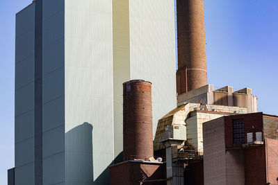 Low angle view of power plant against sky