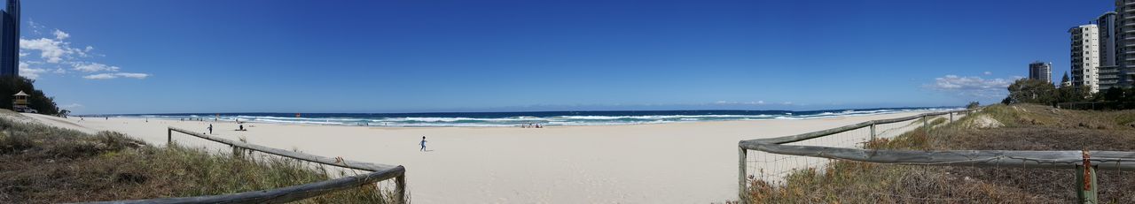Panoramic view of beach against clear blue sky