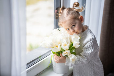 Portrait of cute girl holding bouquet