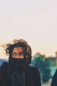 Portrait of woman against sky during sunset