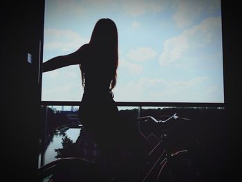 Woman standing against sky