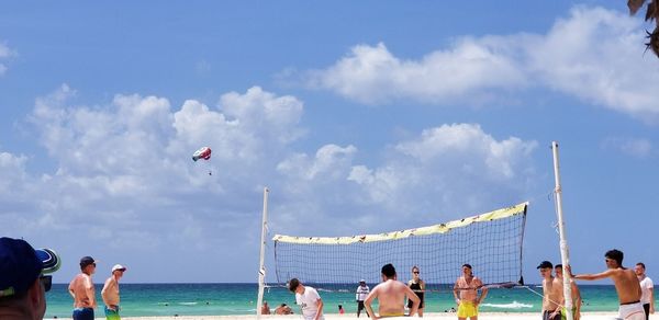 People on beach against sky