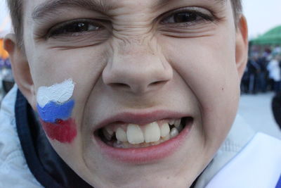 Close-up portrait of teenage boy making face