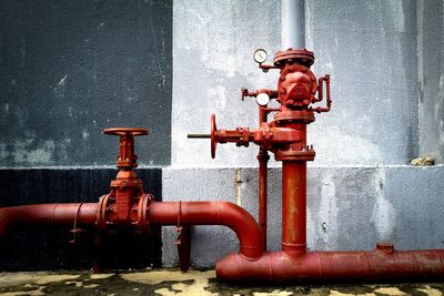 Close-up of fire hydrant against wall