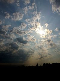 Scenic view of silhouette field against sky during sunset