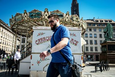 Full length of man standing against sky in city