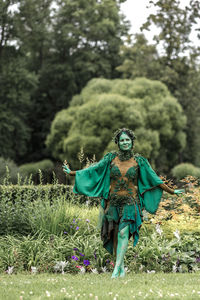 Rear view of woman standing on field