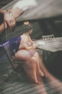 Double exposure of woman sitting at table