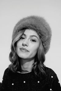 Close-up portrait of young woman against white background