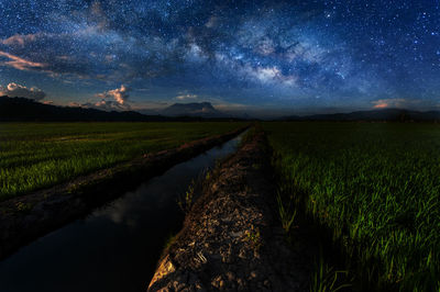 Scenic view of land against sky at night