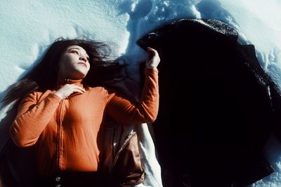 Portrait of young woman looking at waterfall