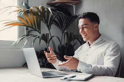 Young man using laptop at office