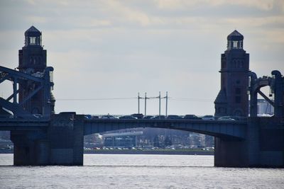 View of bridge over river against cloudy sky
