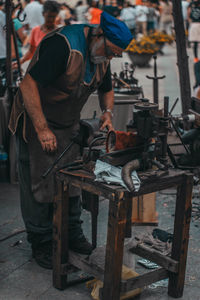 Man working on metal structure in factory