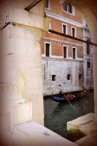 Rear view of people on boat against building