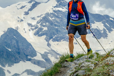 Low angle view of man walking on mountain