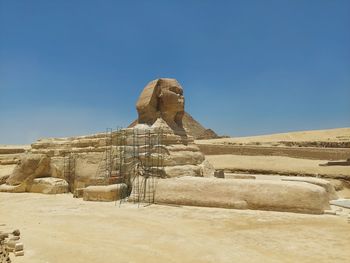 Rock formations in desert against clear blue sky